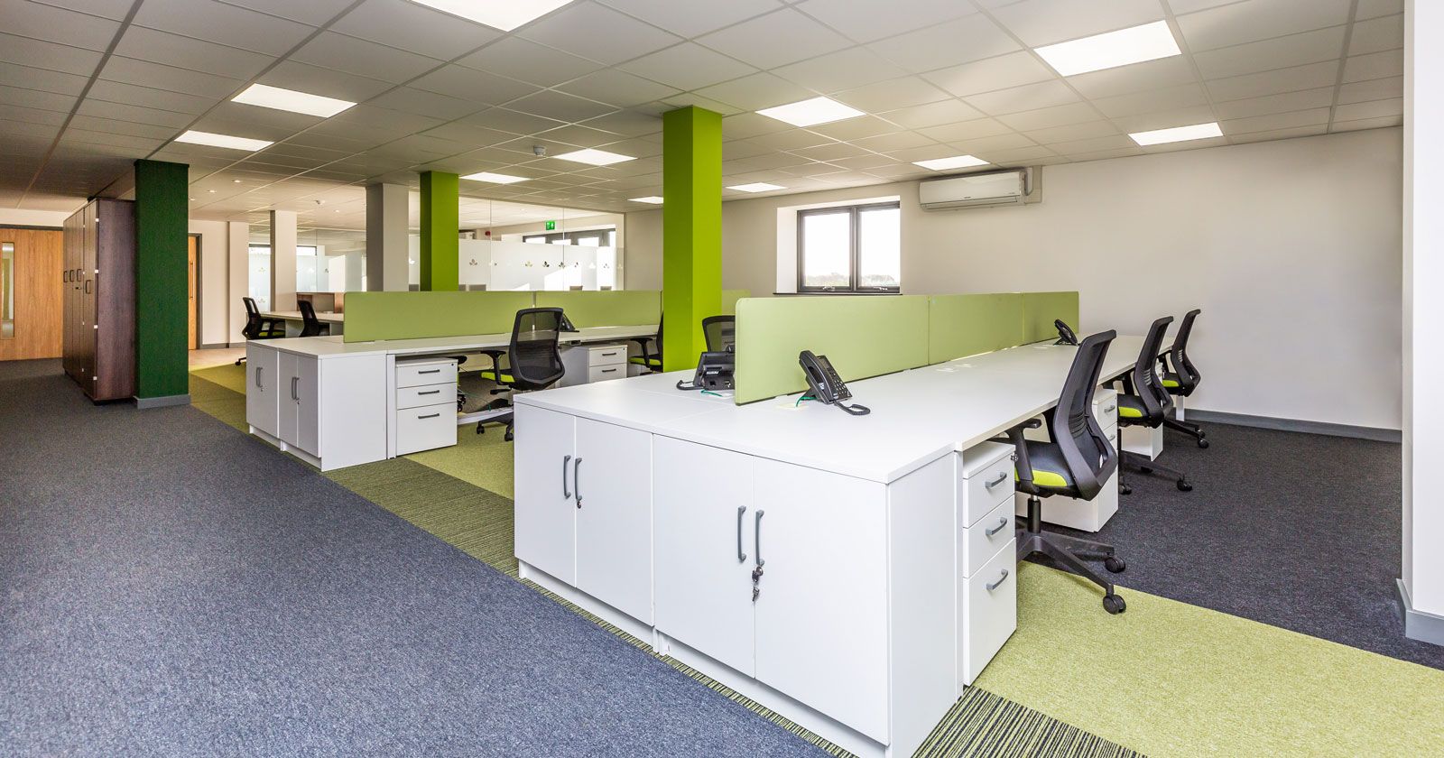 British Hardwood Tree Nursery Open Plan Office Design with Feature Green Carpet Walls and Glass Partitions by APSS