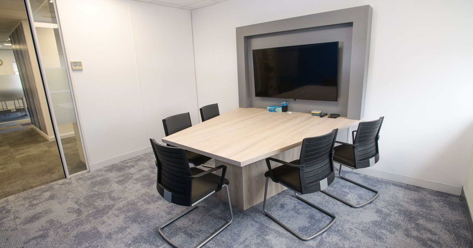 Charnwood-Accountants-Meeting-desk-and-media-wall-surround-designed-built-and-installed--by-APSS-Joinery