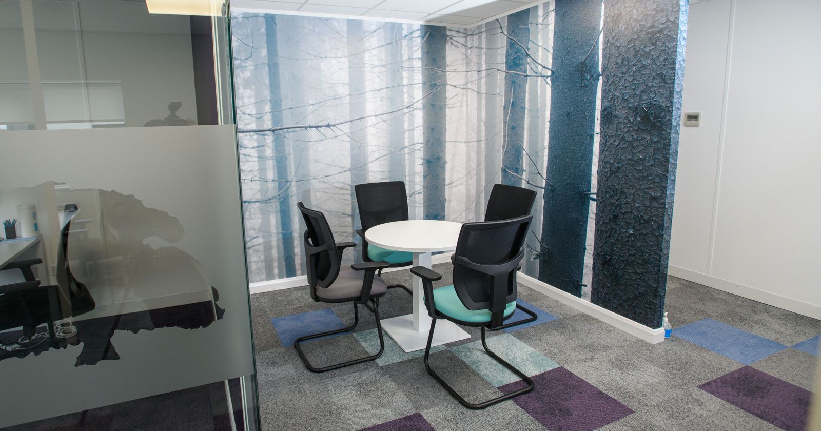 Charnwood-Accountants-meeting-area-huddle-desk-with-floor-to-ceiling-graphics-nature-trees-by-APSS