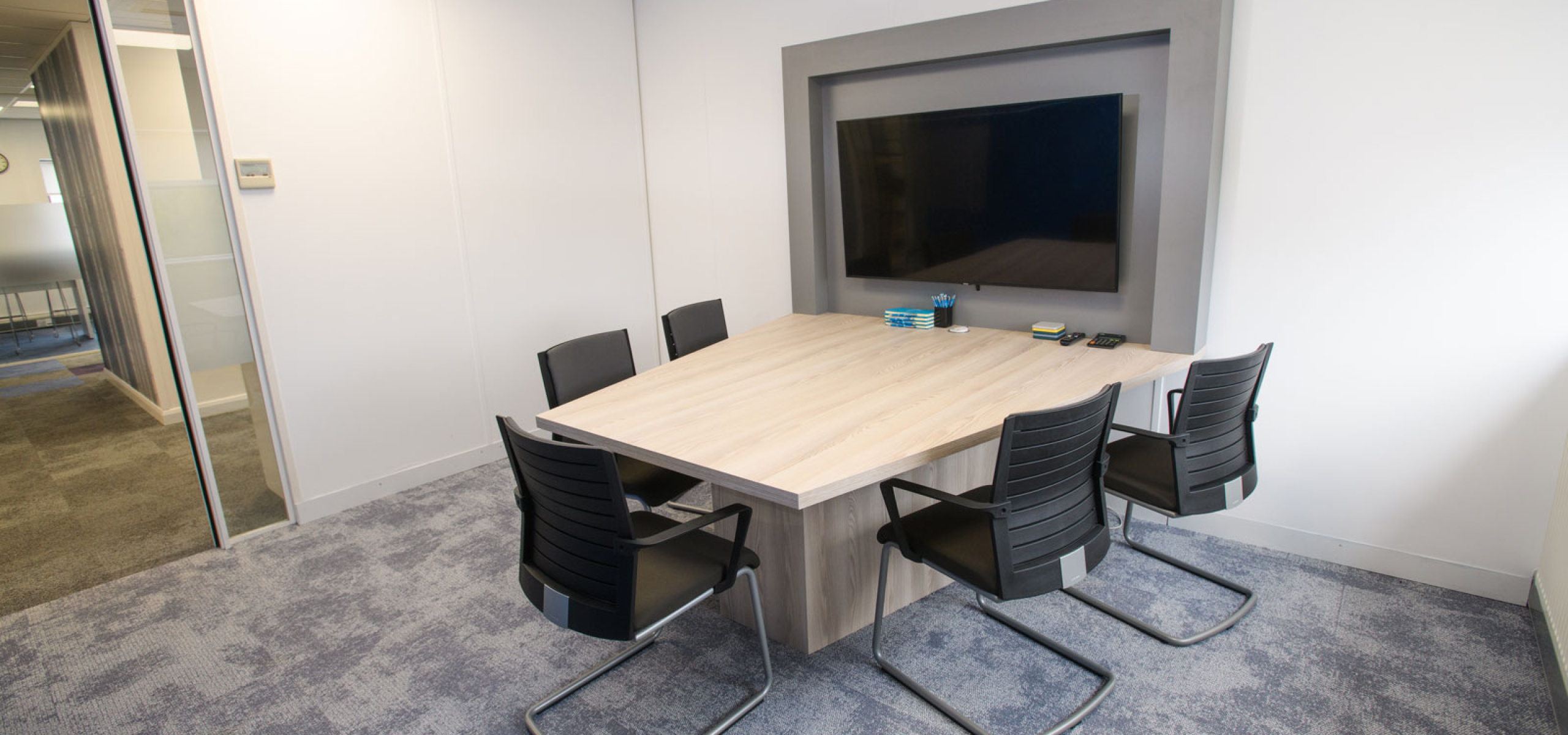 Charnwood-Accountants-Meeting-desk-and-media-wall-surround-designed-built-and-installed--by-APSS-Joinery
