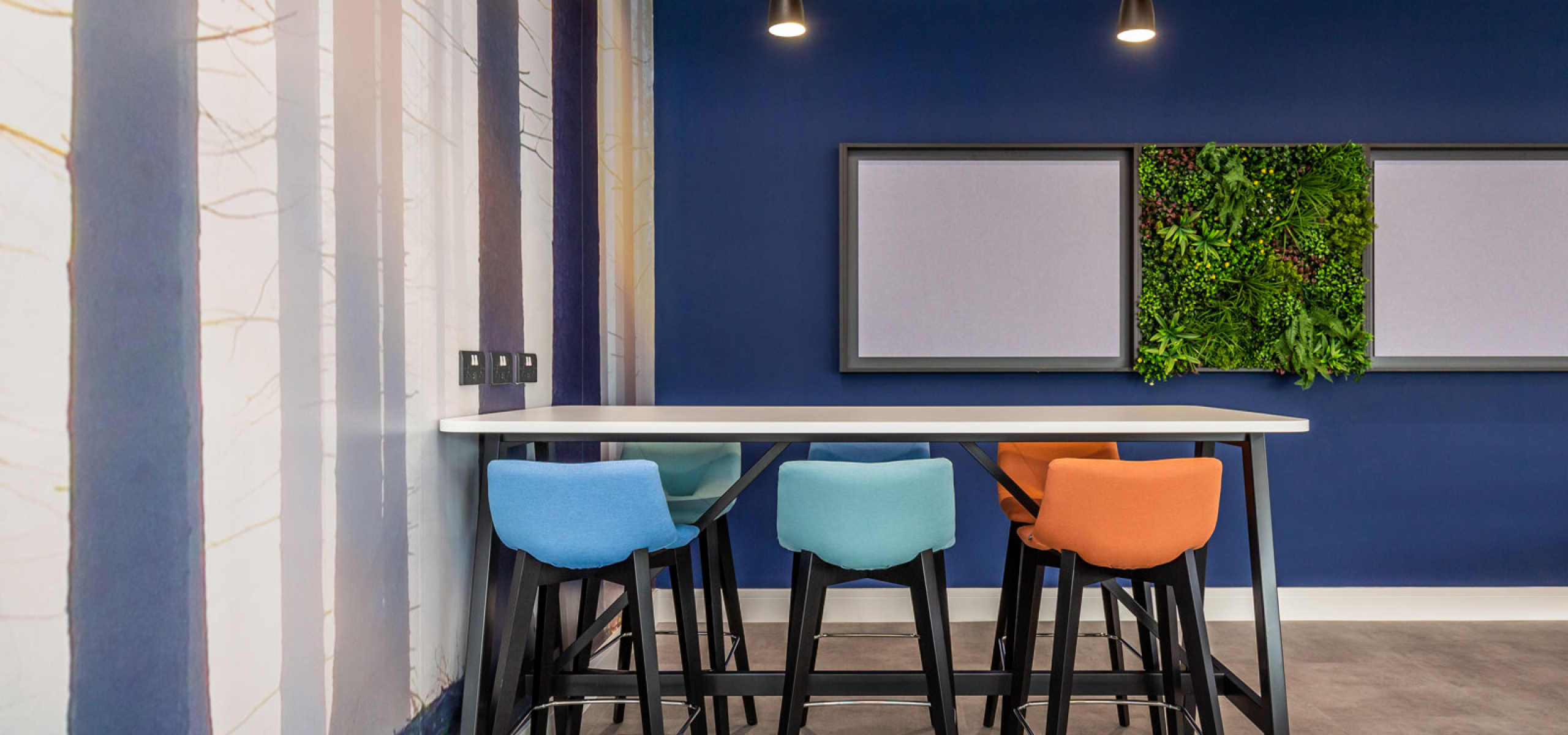 High Table seating area breakout space with feature wall and notice board