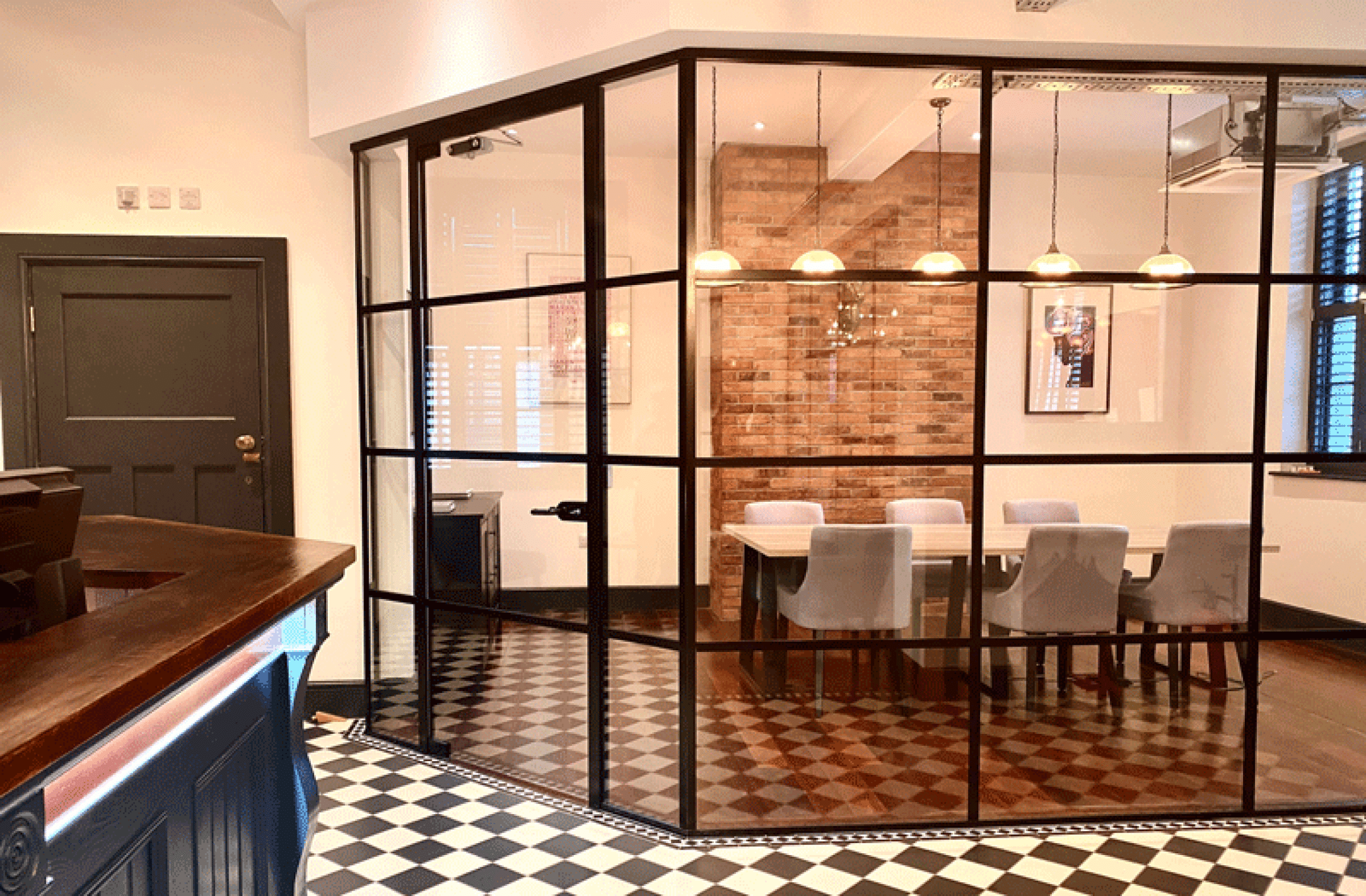 Crittall effect glass office partitions installed by APSS to create an office meeting room.
